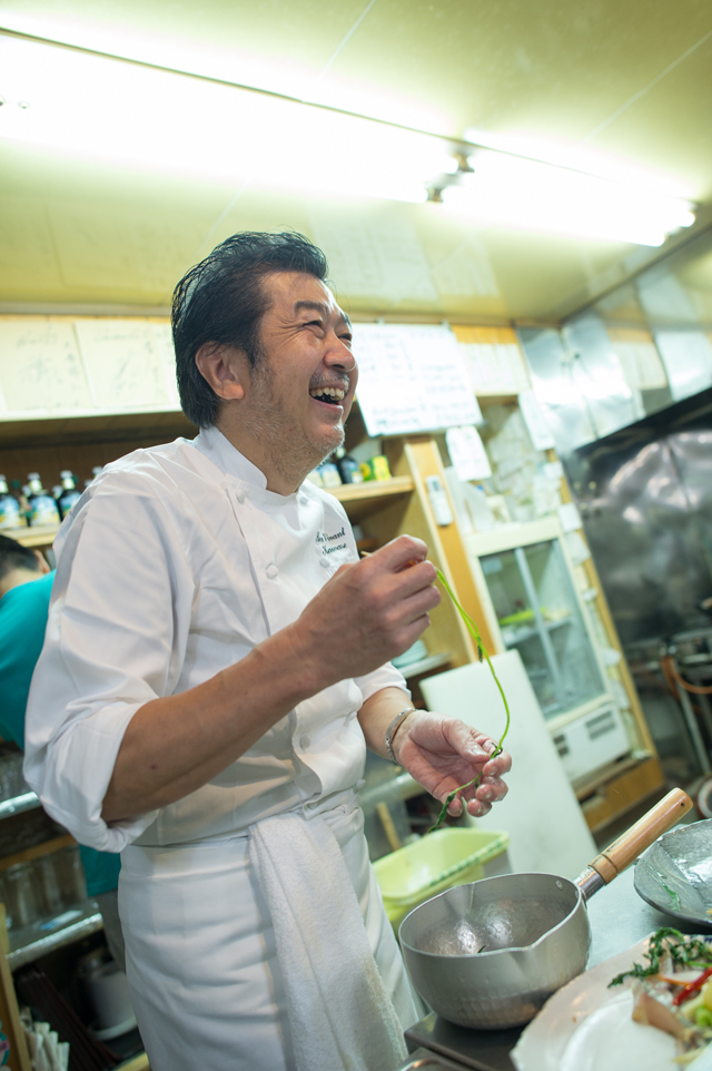 Chef Kawase laughing at the fishermen’s talk as he cooks