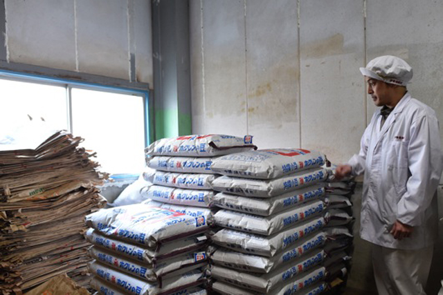 Shop foreman Mr. Kitamura stands in front of top quality Miyabi brand adzuki beans from Tokachi in Hokkaido