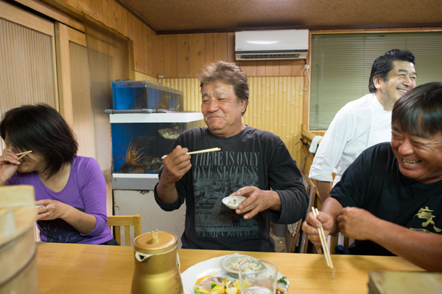 The 3 fishermen sampling the dishes